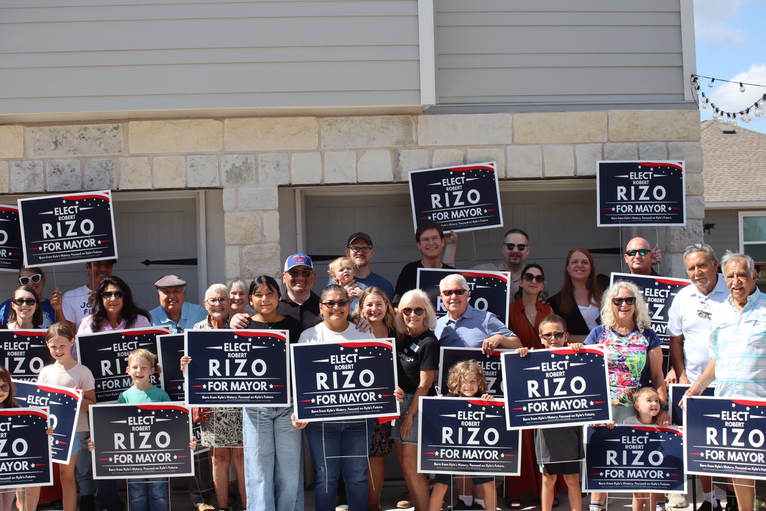 Robert Rizo supporters holding campaign signs at a community gathering